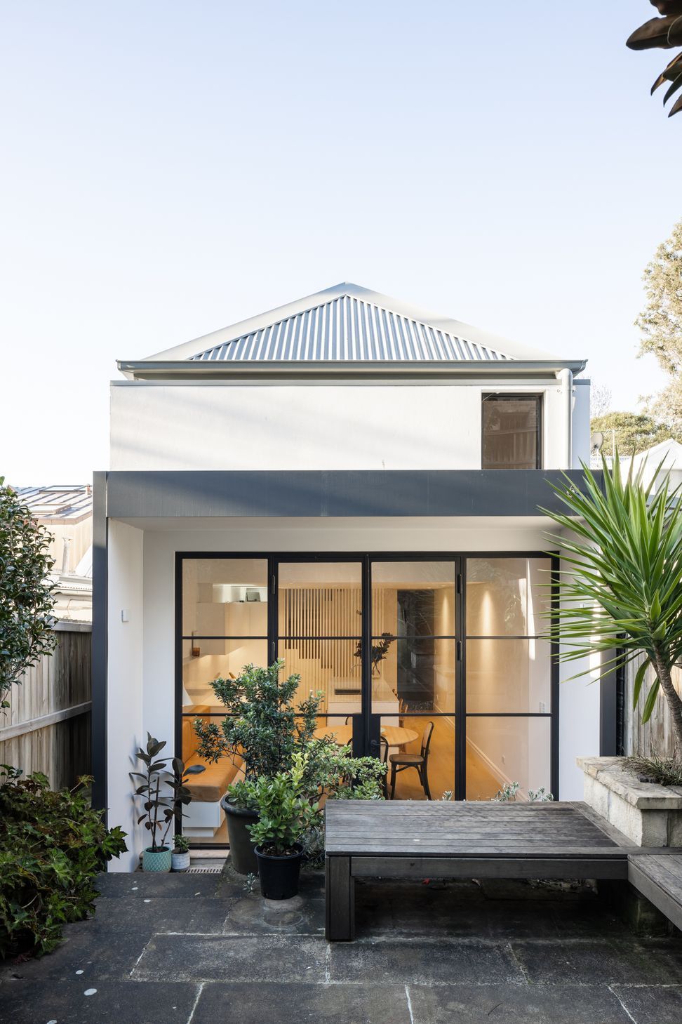 Sensitive rear extension with steel doors framing the interior and exterior spaces