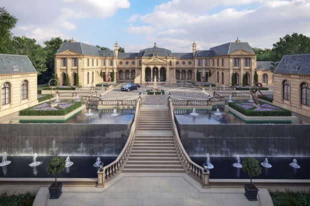 A grand symmetrical French chateau-style estate viewed from an elevated central axis. The formal stone-coloured building features mansard roofs, ornate classical facades, arched windows, columns, pediments, and decorative roofline elements. Broad terraces and monumental stairways descend through meticulously geometrical gardens with clipped topiary, flower beds, multiple reflecting pools, cascading water features, and fountains. The scene has a highly polished, stately and luxurious character.