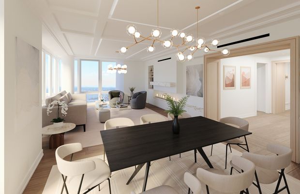 Bright, refined open-plan living and dining area with a large dark timber dining table, upholstered contemporary dining chairs, a neutral sofa and lounge seating, and a sculptural branch-style pendant light. White coffered ceilings, decorative wall mouldings, timber flooring, and wide glazed openings create an airy apartment-like interior with water visible beyond the windows.