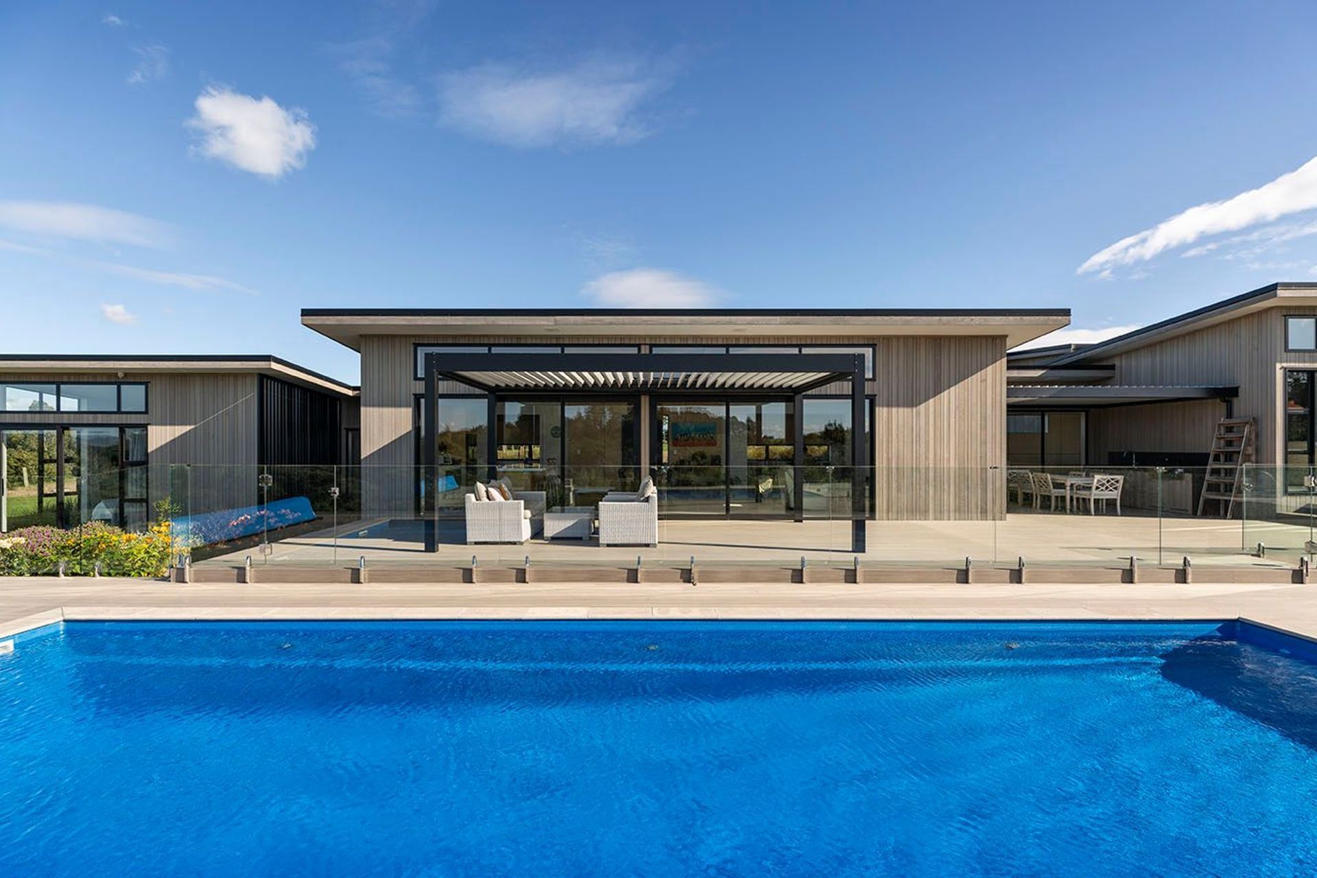 Blonded exterior cedar cladding adds a country feel to the mono pitch forms, which all open to the northern deck area and inground pool.