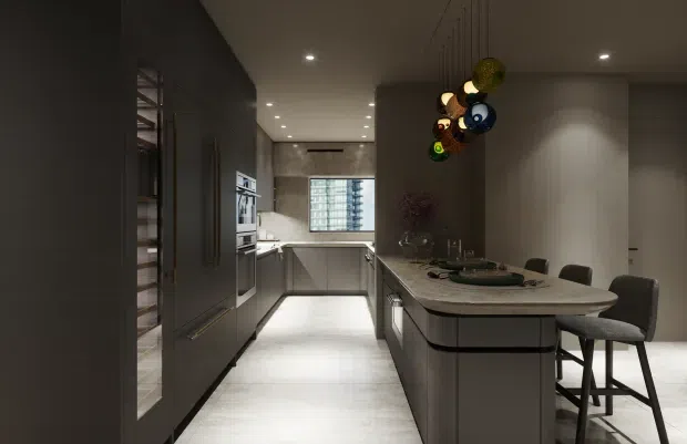 A sophisticated contemporary kitchen and dining area with dark full-height cabinetry, pale stone surfaces, integrated appliances, and a central island with rounded ends and bar seating. The space has a restrained neutral palette, recessed ceiling lighting, a large window at the rear, and a sculptural cluster pendant light above the island.