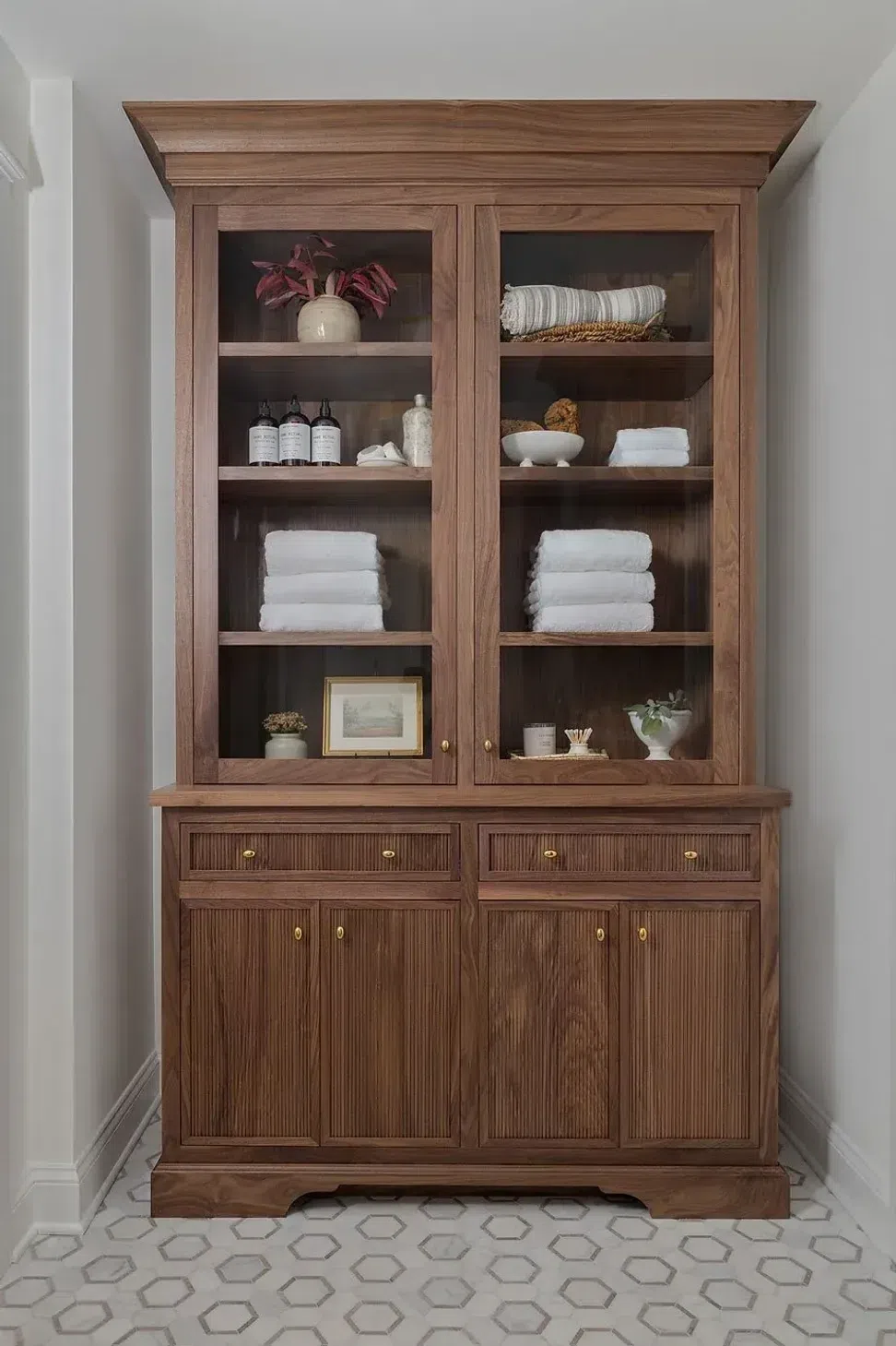 natural-wood-cabinet-bathroom-storage-marble-hexagon-tile-floor-sharp-and-grey-interiors.webp