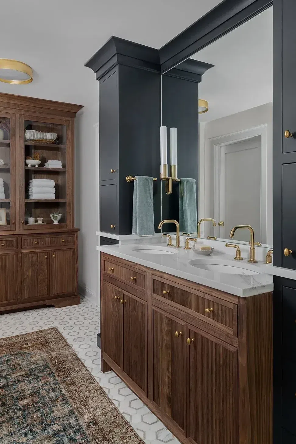 parisian-inspired-bathroom-solid-wood-storage-cabinet-vanity-marble-top-gold-fixtures-sharp-and-grey-interiors.webp
