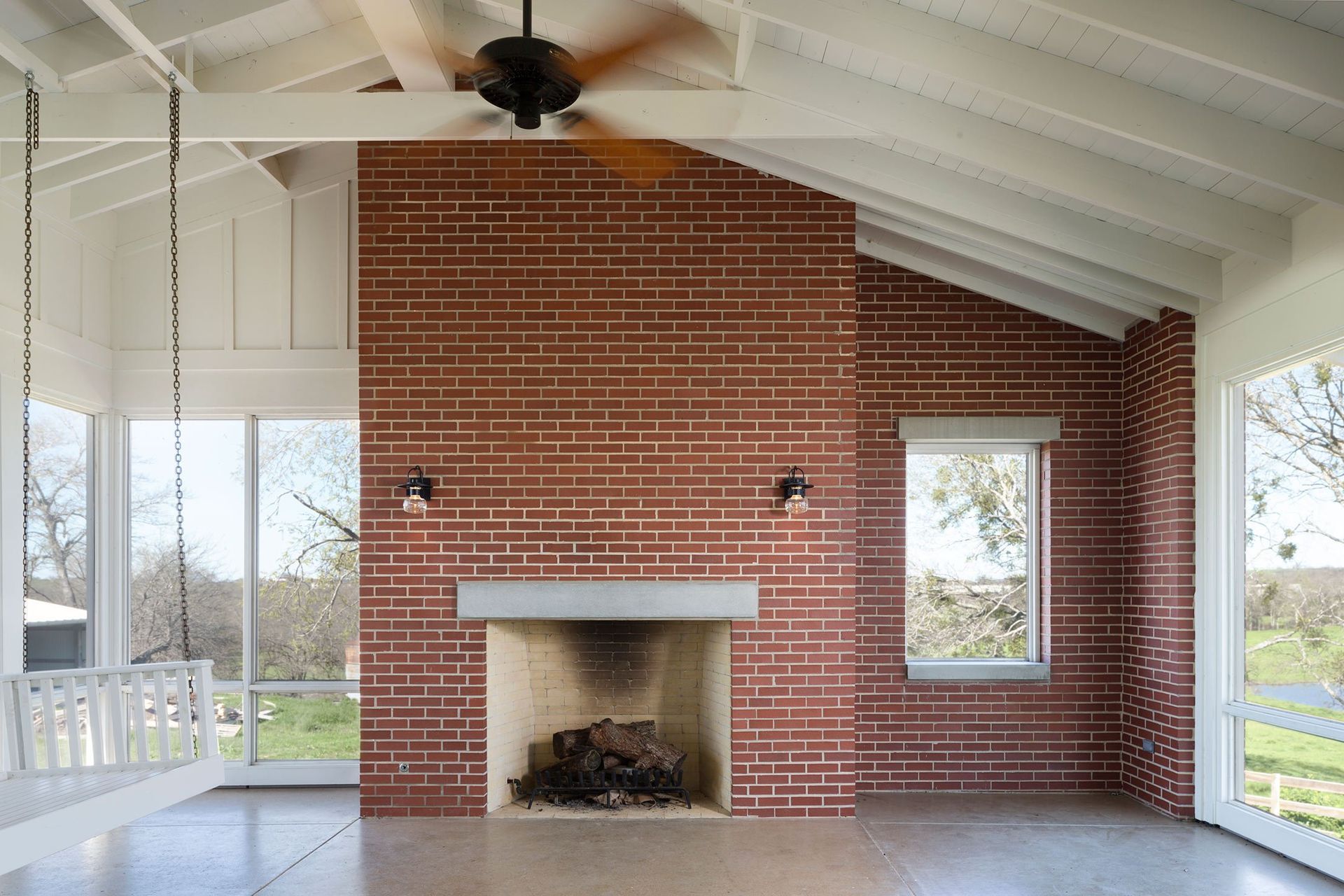 11PendletonFarmCuppettKilpatrickArchitectureandInteriorDesignaustin-tx-farmhouse-screened-porch-brick-fireplace.jpg