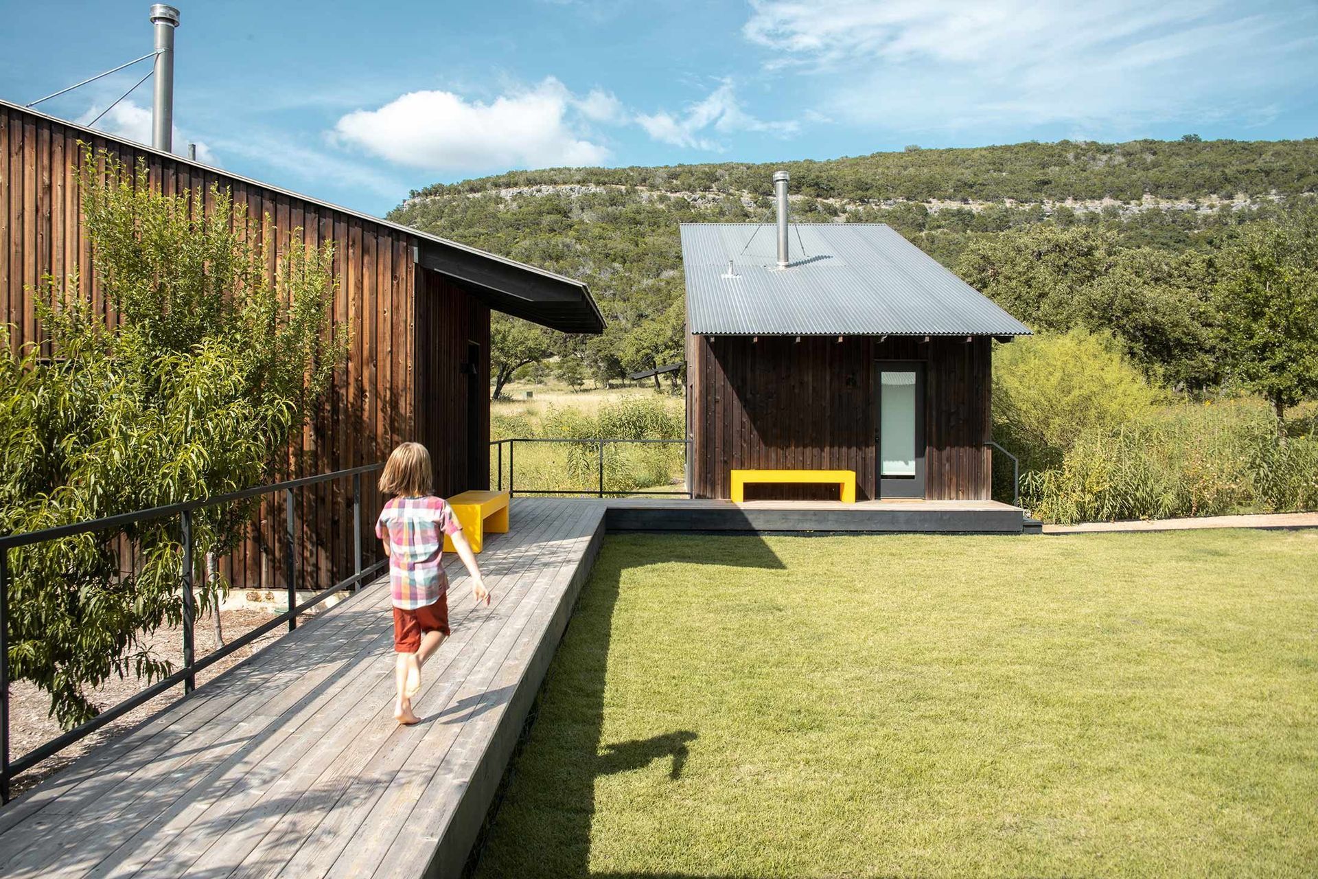 6CampFrioCuppettKilpatrickArchitectureandInteriorDesignfamily-friendly-cabins-wooden-deck-hillside-view.jpg