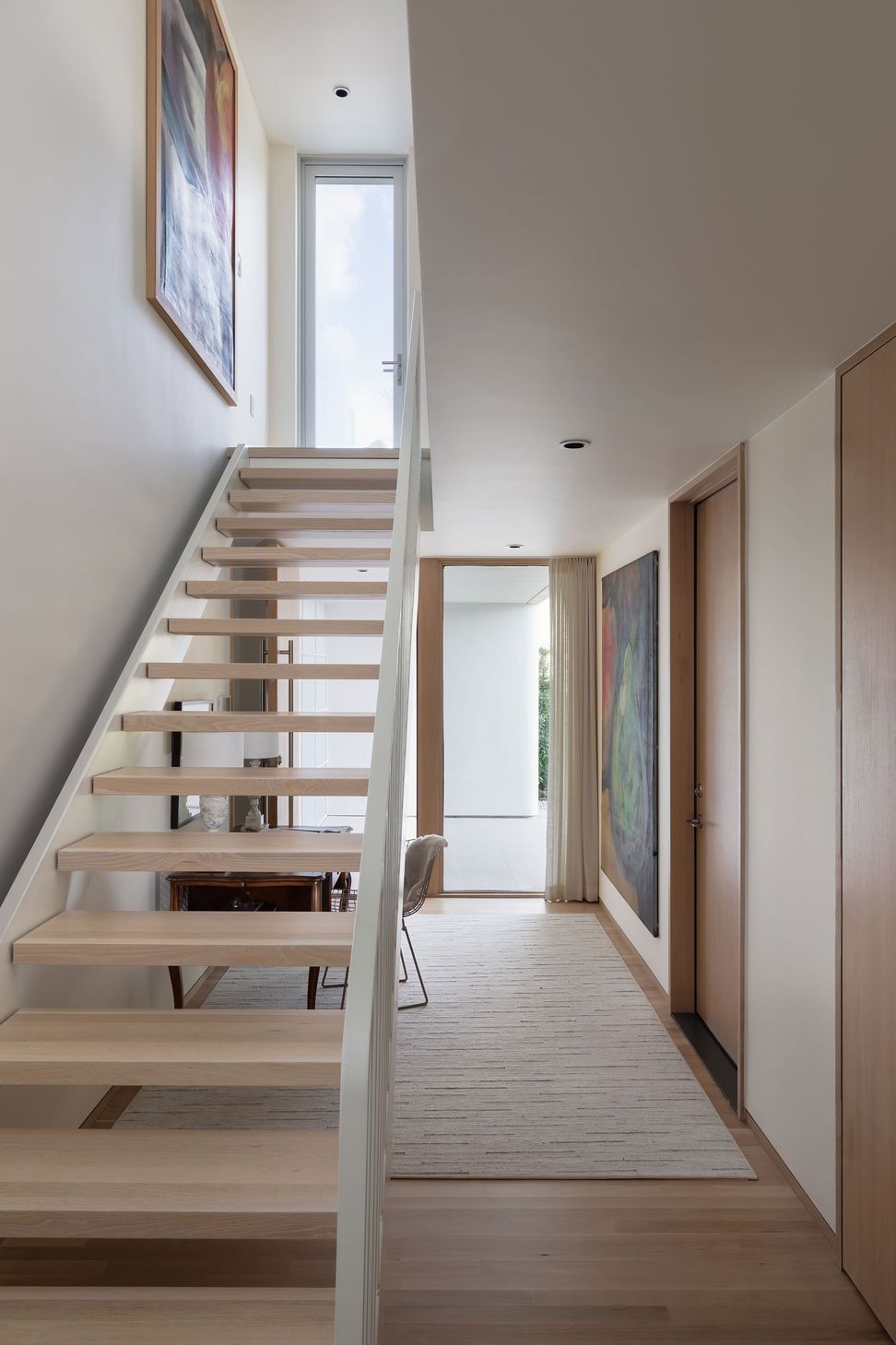 4WethersfieldTownhouseCuppettKilpatrickArchitectureandInteriorDesignmodern-minimalist-interior-wood-staircase-steel-railing-natural-light.jpg