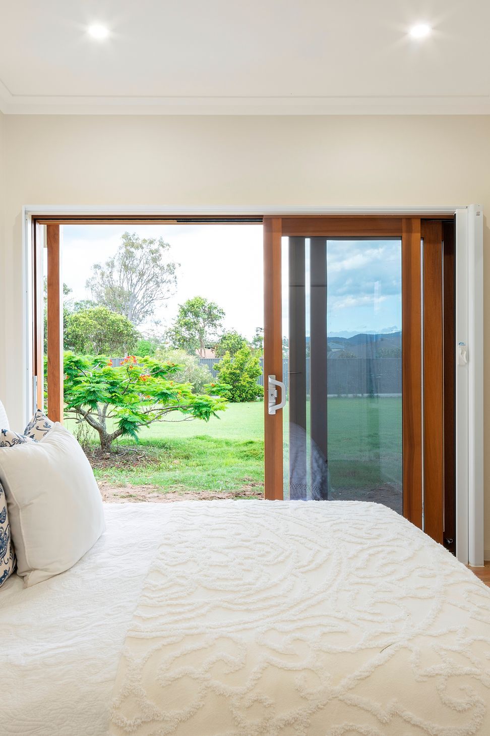 The bedroom is designed to allow a bedbound person to still experience a visual connection to the land. It is protected from western sun while still welcoming a generous winter warming.  Photo:®Angus Martin