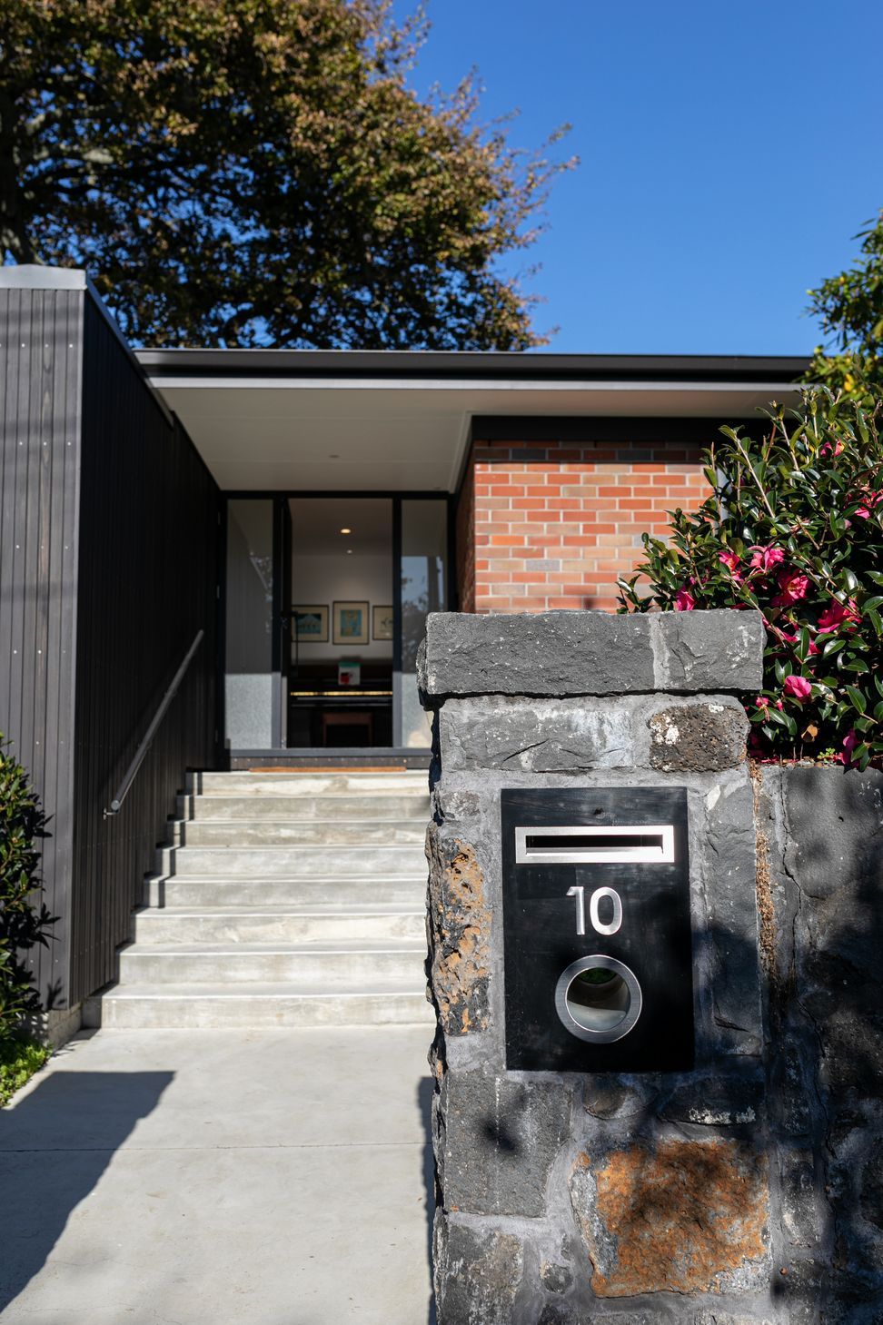 The contrast of old and new is experienced from the front of the dwelling.