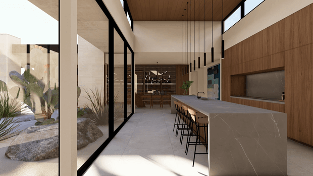 Contemporary open-plan kitchen with a large stone island and integrated breakfast bar, warm timber wall cabinetry, pale tiled flooring, black-framed floor-to-ceiling glazing, and a timber-lined ceiling. A dining area and courtyard landscaping are visible beyond the kitchen, with a linear cluster of suspended pendant lights above the island.