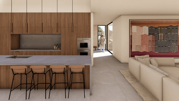 Open-plan contemporary kitchen and living area with full-height warm timber cabinetry, a large stone island with four bar stools, integrated appliances, pale tiled flooring, and a cream sectional sofa. A large framed abstract textile artwork provides a strong accent in the living zone, while a glazed entry or hallway is visible beyond.