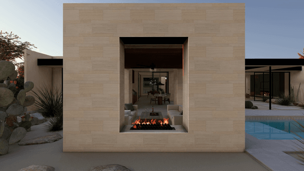Modern single-storey residence with a minimalist rectangular stone-clad facade framing a recessed outdoor fireplace. The opening provides a view through the living area toward the courtyard, with a swimming pool visible to the right, desert landscaping and agave-style planting, and dark flat roof forms extending on either side.