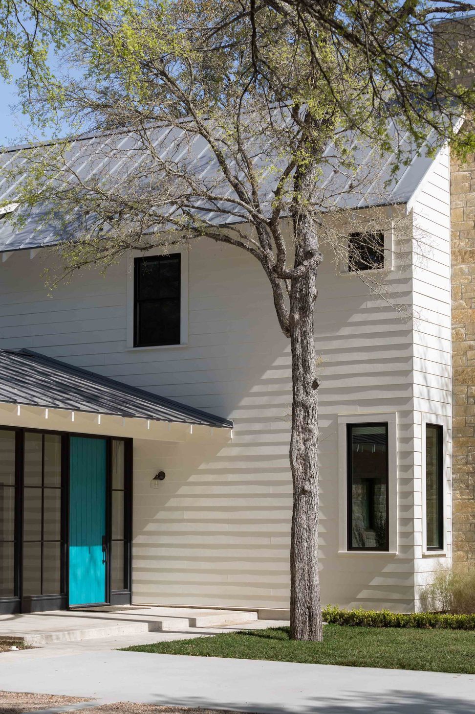 03BunnyRunCuppettKilpatrickArchitectureandInteriorDesignausitn-tx-detail-metal-roof-teal-door-stone-accents.jpg