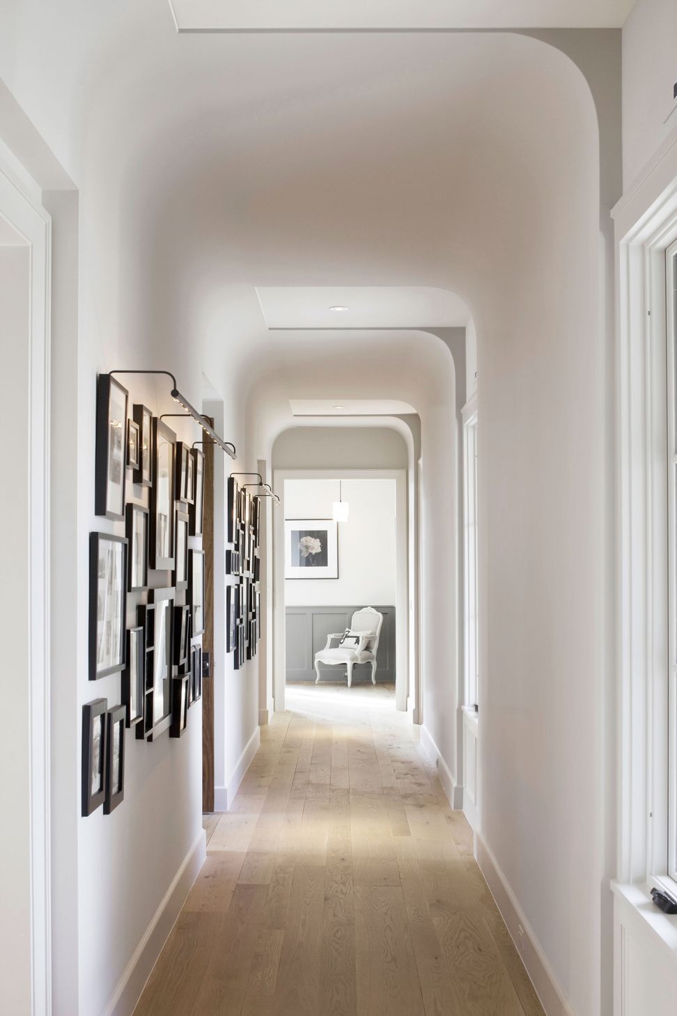 11UrbanHomesteadCuppettKilpatrickArchitectureandInteriorDesignaustin-tx-gallery-hallway-rolled-ceiling-photo-frames.jpg
