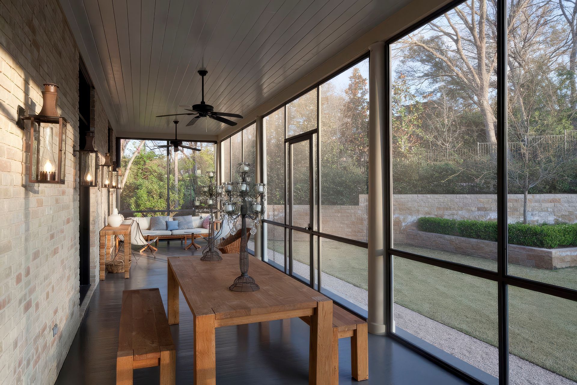 19UrbanHomesteadCuppettKilpatrickArchitectureandInteriorDesignaustin-tx-screened-porch-brick-walls-wooden-furniture-upscaled-by-Replicate.jpg