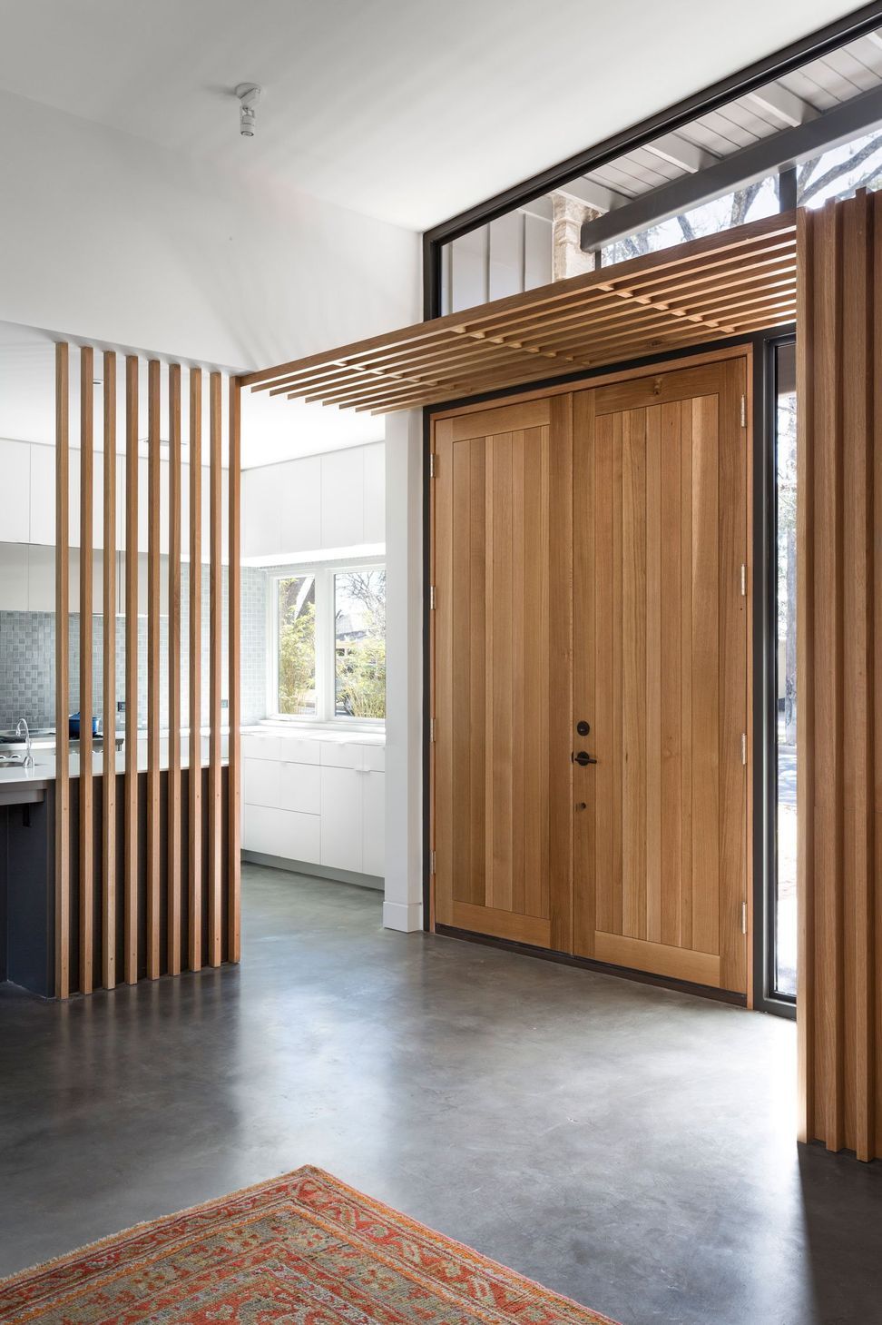 5RiverRoadCuppettKilpatrickArchitectureandInteriorDesignaustin-tx-entryway-wood-slats-kitchen-adjacent.jpg